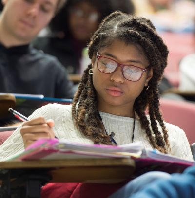 SIU students studying from binders in classroom